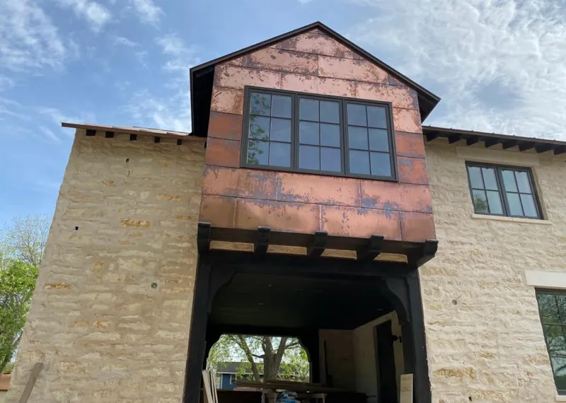 Copper metal panel facade on a stone building for Metal Roof Coating in Clinton
